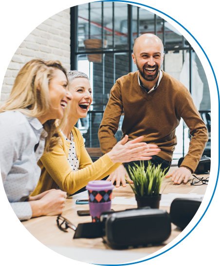 Team members laughing together during a meeting
